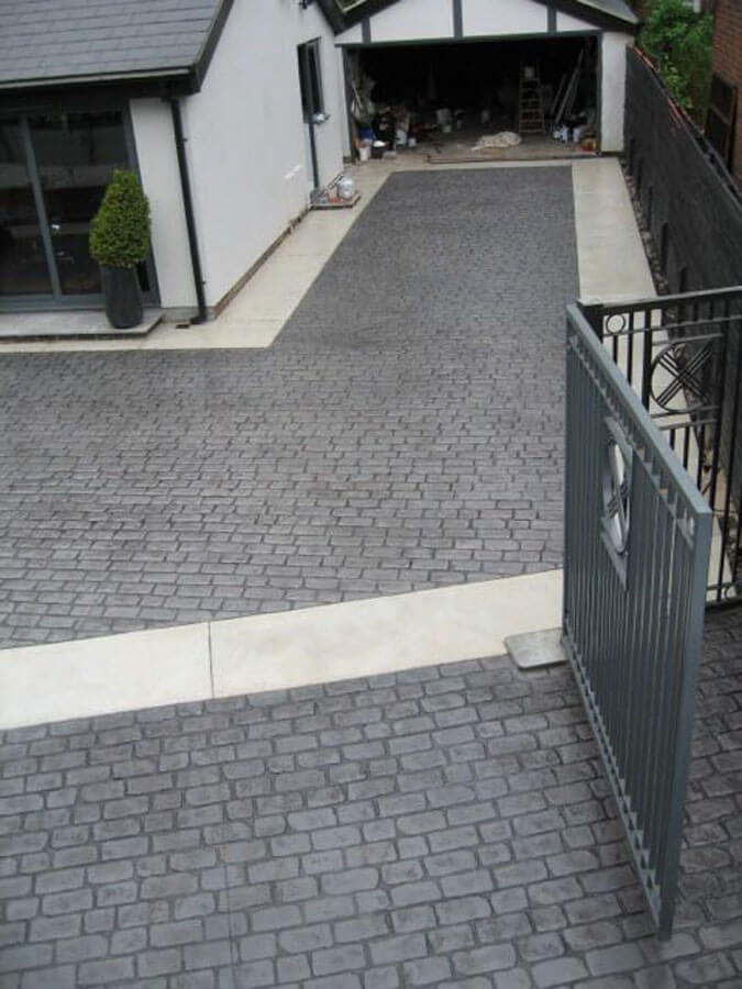 Pattern imprinted concrete driveway with gate